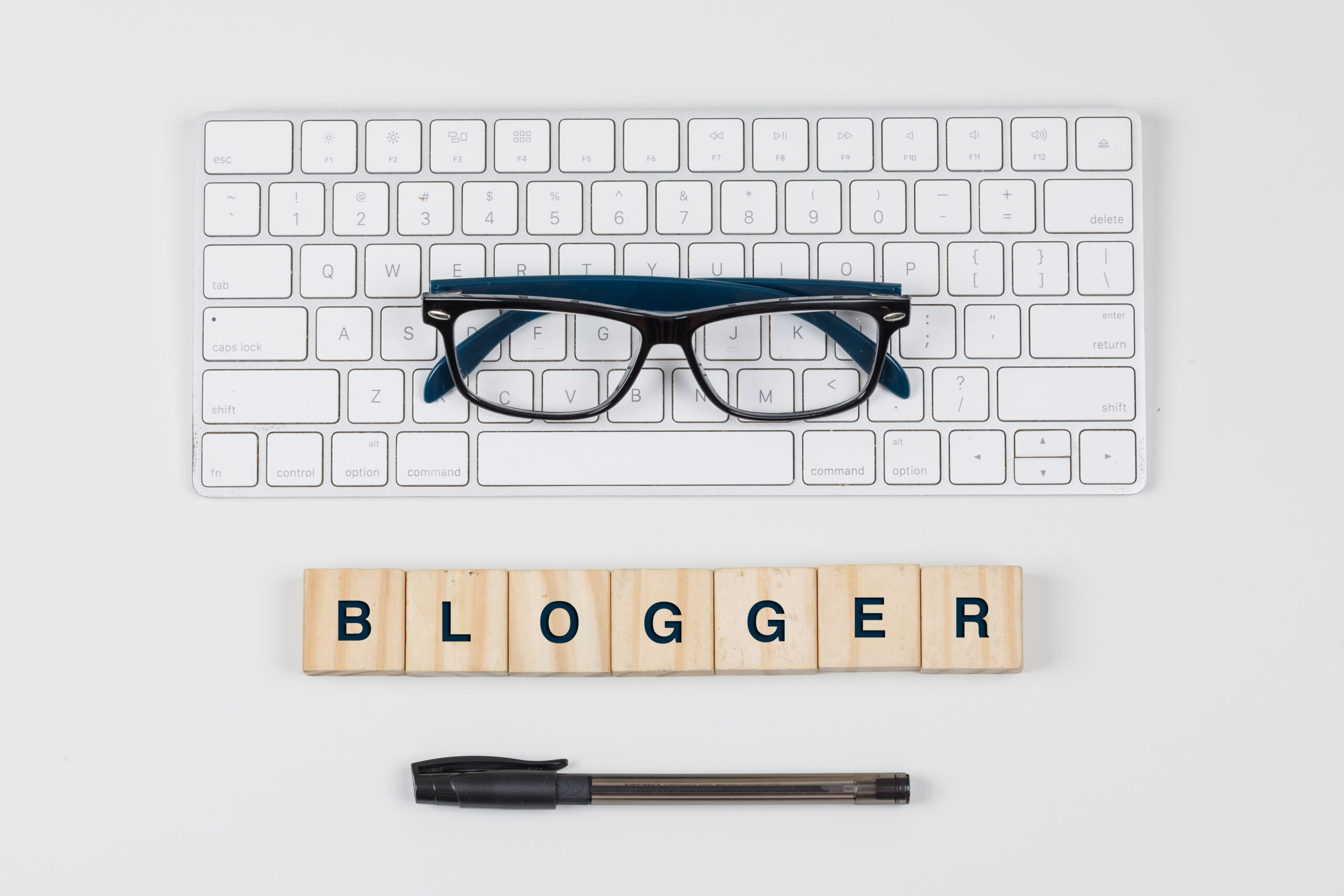 Social media and business concept with wooden blocks, keyboard, glasses, pen on white background flat lay.